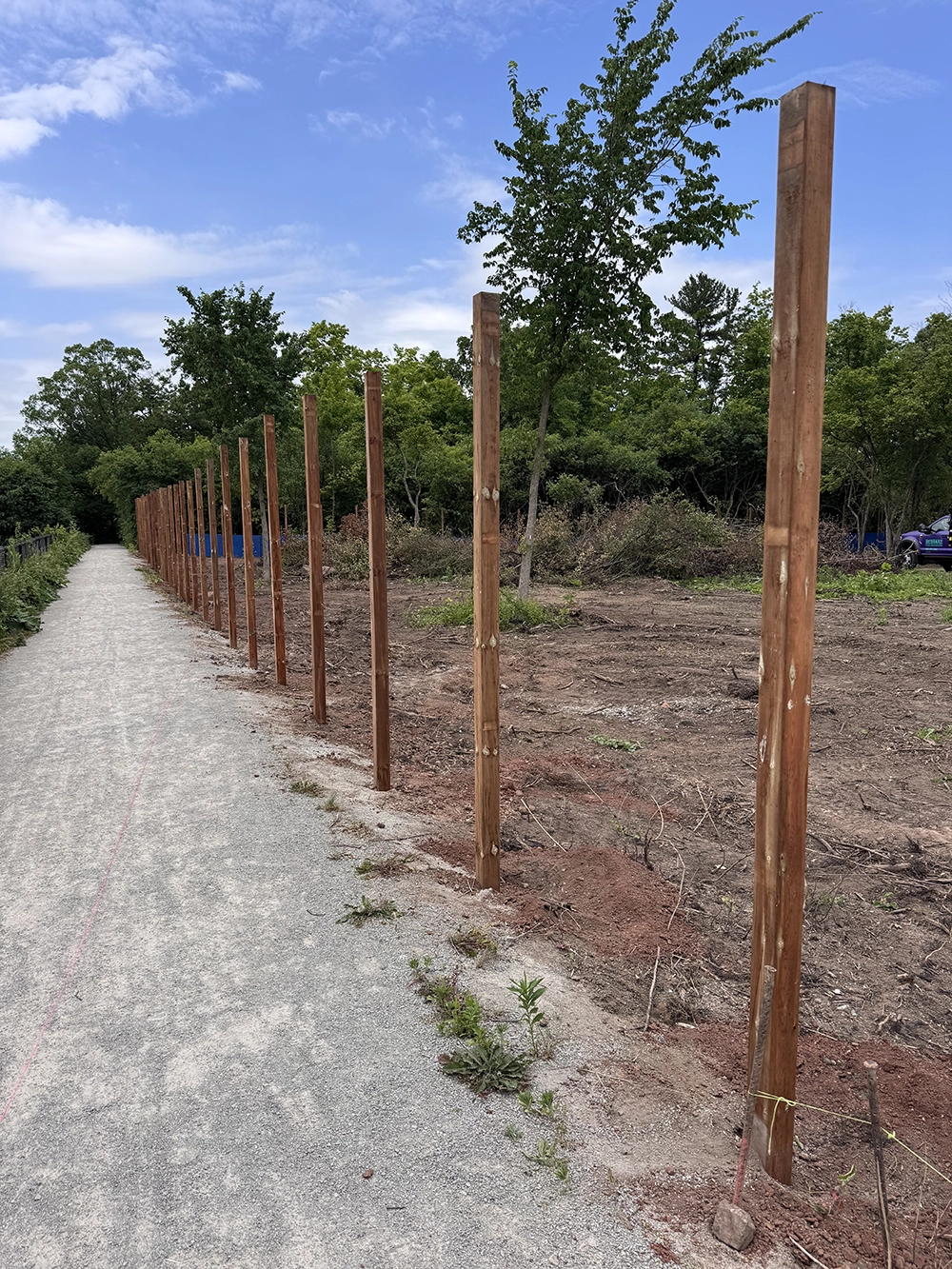 Professional wood fence posts installed along walkway in Vaughan Ontario residential landscape